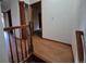 Hallway with wood-look flooring and neutral-colored walls at 3136 S Cathay Cir, Aurora, CO 80013
