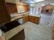 Bright kitchen features wood cabinets, granite countertops, stainless steel appliances, and hardwood-style floors at 3136 S Cathay Cir, Aurora, CO 80013