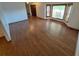 Open-concept living area featuring hardwood floors, a bay window, and easy access to other rooms at 3136 S Cathay Cir, Aurora, CO 80013