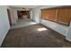 Open living room with access to the kitchen, plenty of light, and carpet flooring at 3136 S Cathay Cir, Aurora, CO 80013