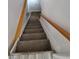 Carpeted staircase with wooden handrails leading to the upper level of the home at 3136 S Cathay Cir, Aurora, CO 80013