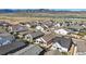 Stunning aerial view of a neighborhood near a lake, showcasing modern homes and scenic mountain views at 11492 Stonewash St, Littleton, CO 80125