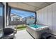 Inviting covered patio area with a hot tub and grill, perfect for outdoor entertaining at 11492 Stonewash St, Littleton, CO 80125