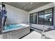 Cozy back patio featuring a hot tub and convenient access to the interior through modern windows at 11492 Stonewash St, Littleton, CO 80125
