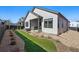 Landscaped backyard with a covered patio and hot tub, creating a private outdoor oasis at 11492 Stonewash St, Littleton, CO 80125