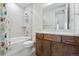 Modern bathroom featuring a shower and tub combination, plus updated white vanity and fixtures at 11492 Stonewash St, Littleton, CO 80125