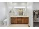 Bathroom featuring a double vanity, walk-in closet, and tiled floors at 11492 Stonewash St, Littleton, CO 80125