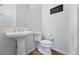 Modern half-bathroom features a pedestal sink, toilet, and stylish decor at 11492 Stonewash St, Littleton, CO 80125