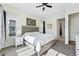 Sunlit bedroom featuring a king bed, ensuite bathroom, and neutral color palette at 11492 Stonewash St, Littleton, CO 80125
