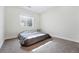 Bedroom with a large window allowing natural light and neutral carpet flooring at 11492 Stonewash St, Littleton, CO 80125