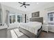Bright bedroom with a king bed, ceiling fan, and windows providing lots of natural light at 11492 Stonewash St, Littleton, CO 80125
