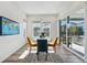 Bright dining area features a modern table, chairs, and a sliding glass door at 11492 Stonewash St, Littleton, CO 80125