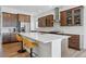 Modern kitchen featuring custom cabinetry, stainless steel appliances, and a stylish island at 11492 Stonewash St, Littleton, CO 80125