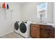 Functional laundry room with a sink, modern washer and dryer set, and stylish tile flooring at 11492 Stonewash St, Littleton, CO 80125