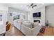 Cozy living room featuring hardwood floors, a modern fireplace, and natural light at 11492 Stonewash St, Littleton, CO 80125