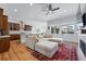 Spacious open-concept living room with a gray sectional, hardwood floors, and a view into the kitchen at 11492 Stonewash St, Littleton, CO 80125