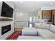 Bright living room features a modern fireplace, TV, and comfortable sectional sofa at 11492 Stonewash St, Littleton, CO 80125