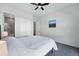 Bright bedroom featuring a ceiling fan, carpet floors, and a closet in a neutral color palette at 11492 Stonewash St, Littleton, CO 80125