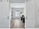 Well-lit home office with a desk, shelving, and wood-look floors at 11492 Stonewash St, Littleton, CO 80125