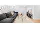 Finished basement featuring a cozy gray sofa, stylish decor, and a sleek coffee table at 418 S Gilpin St, Denver, CO 80209