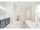 Bright bathroom features a glass enclosed shower, soaking tub, and modern vanity at 418 S Gilpin St, Denver, CO 80209