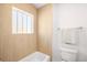 Bright bathroom featuring a white bathtub, a window, and modern wood-look accent wall at 418 S Gilpin St, Denver, CO 80209