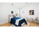 Cozy bedroom with neutral walls, hardwood floors, and a comfortable twin bed with stylish accents at 418 S Gilpin St, Denver, CO 80209