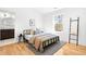 Bedroom with modern finishes, hardwood flooring, and a large window providing natural light at 418 S Gilpin St, Denver, CO 80209