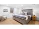 Primary bedroom with gray furniture, wood-look flooring, and a sunlit window at 418 S Gilpin St, Denver, CO 80209