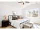 Bedroom with a large window, neutral accents, and a ceiling fan at 418 S Gilpin St, Denver, CO 80209