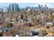 A picturesque view of the city skyline and residential neighborhood, surrounded by mature trees and landscaping at 418 S Gilpin St, Denver, CO 80209