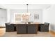 Bright dining room features modern lighting, a large window, and sleek grey chairs at 418 S Gilpin St, Denver, CO 80209