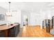 Elegant dining room featuring hardwood floors, a modern chandelier, and seamless integration with the rest of the home at 418 S Gilpin St, Denver, CO 80209