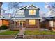 Charming two-story home with brick accents, inviting front porch, and landscaped yard at 418 S Gilpin St, Denver, CO 80209