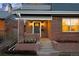 Welcoming front entrance with a brick facade, a cozy porch, and vibrant flowers adding charm to the home at 418 S Gilpin St, Denver, CO 80209
