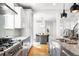 Well-lit kitchen with sleek countertops, stainless steel appliances, and an open layout at 418 S Gilpin St, Denver, CO 80209
