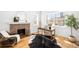 Cozy living room featuring a brick fireplace, home office setup, and natural light at 418 S Gilpin St, Denver, CO 80209