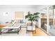 Bright living room featuring modern furniture, hardwood floors, and large windows at 418 S Gilpin St, Denver, CO 80209