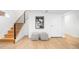 Modern staircase with wooden steps, sleek black railing, and stylish checkered ottoman at 418 S Gilpin St, Denver, CO 80209