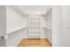 Walk-in closet with built-in shelving and hanging racks, all illuminated by natural light at 418 S Gilpin St, Denver, CO 80209