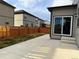 Spacious backyard featuring a concrete patio, partial grass, and a wooden fence at 1109 Sunrise Dr, Lochbuie, CO 80603