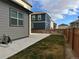 Grassy backyard area with concrete patio and view of neighboring houses at 1109 Sunrise Dr, Lochbuie, CO 80603