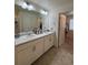 Bathroom with double sink vanity, large mirror, and neutral color scheme at 1109 Sunrise Dr, Lochbuie, CO 80603