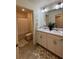 Bright bathroom featuring a double vanity, tub-shower, and tiled flooring at 1109 Sunrise Dr, Lochbuie, CO 80603