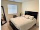 Cozy bedroom featuring a large window and a full-length mirror at 1109 Sunrise Dr, Lochbuie, CO 80603