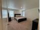 Spacious bedroom with a comfortable bed, neutral tones, and ample natural light from the windows at 1109 Sunrise Dr, Lochbuie, CO 80603