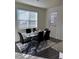 Elegant dining room with stylish table and large window at 1109 Sunrise Dr, Lochbuie, CO 80603