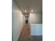 Well-lit hallway with neutral carpeting and access to multiple rooms at 1109 Sunrise Dr, Lochbuie, CO 80603