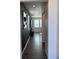Hallway with dark accent wall, modern lighting and contrasting baseboards at 1109 Sunrise Dr, Lochbuie, CO 80603