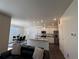 Bright open-concept kitchen flows into the dining area with stainless steel appliances and granite countertops at 1109 Sunrise Dr, Lochbuie, CO 80603